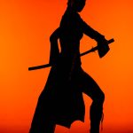 silhouette of woman in costume with sword