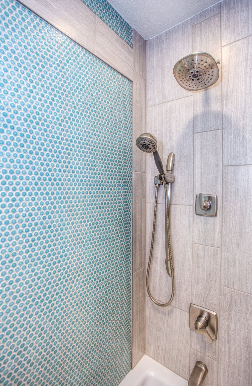 stainless steel shower head inside bathroom