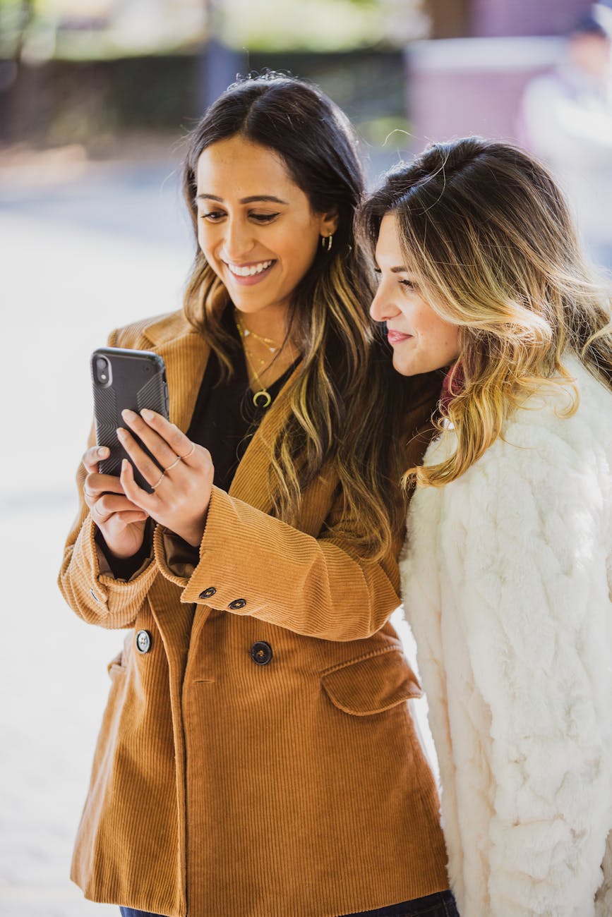 photo of woman holding smartphone
