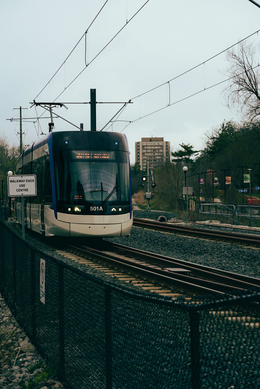modern tram approaching urban railway station