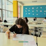 focused student taking test in classroom