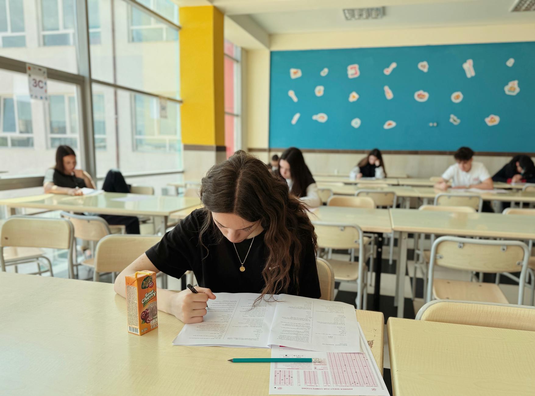focused student taking test in classroom