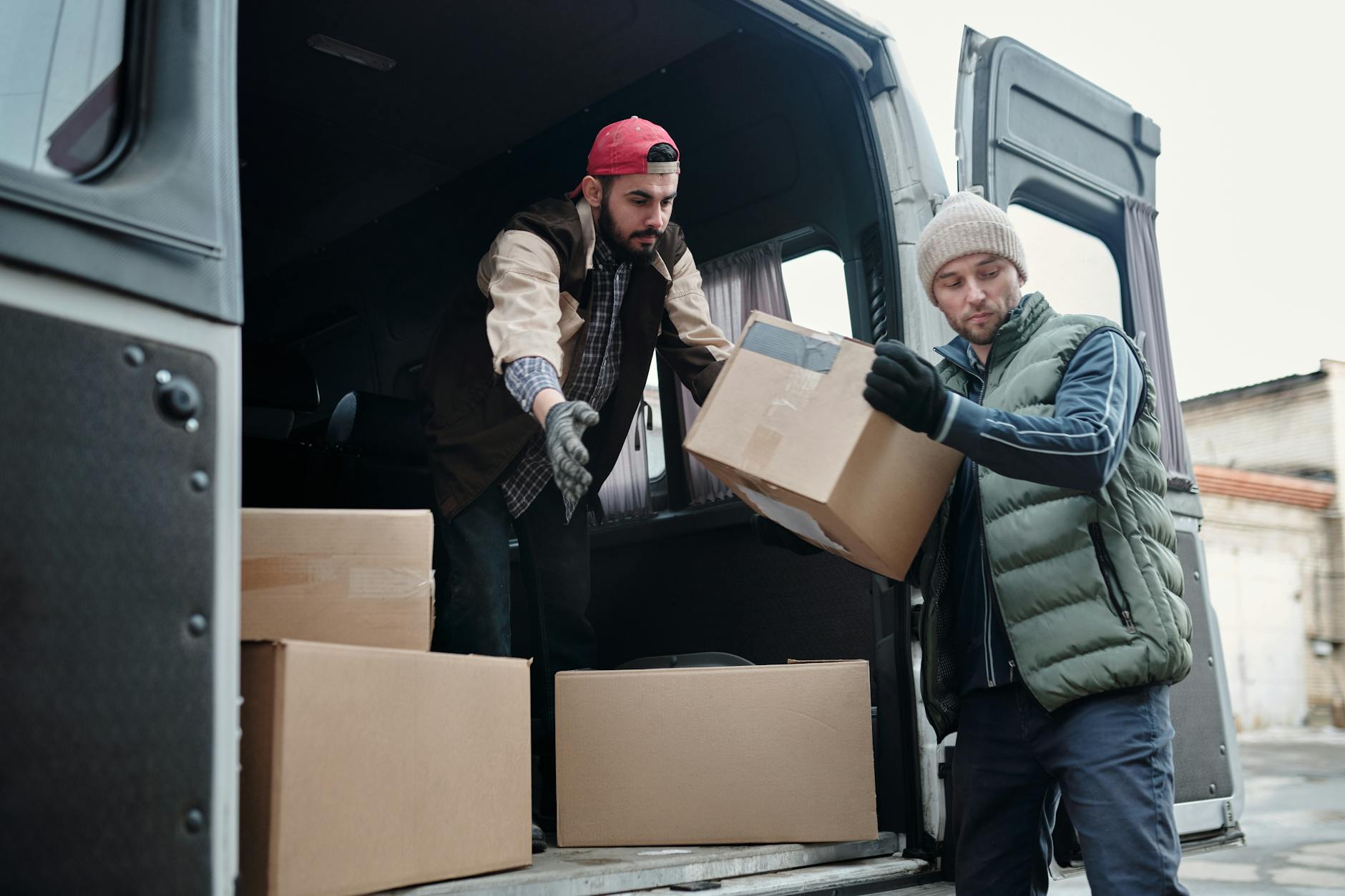 men taking boxes out of van