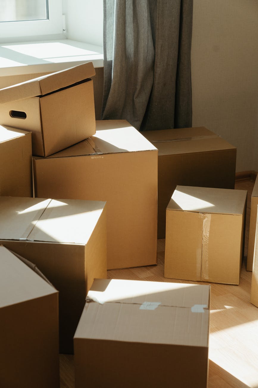brown cardboard boxes on white ceramic tiles
