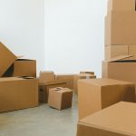 pile of cardboard boxes scattered on floor during relocation