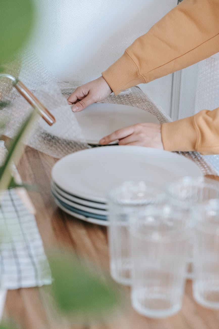 woman putting bubble wrap on plates
