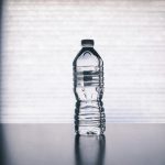 clear disposable bottle on black surface