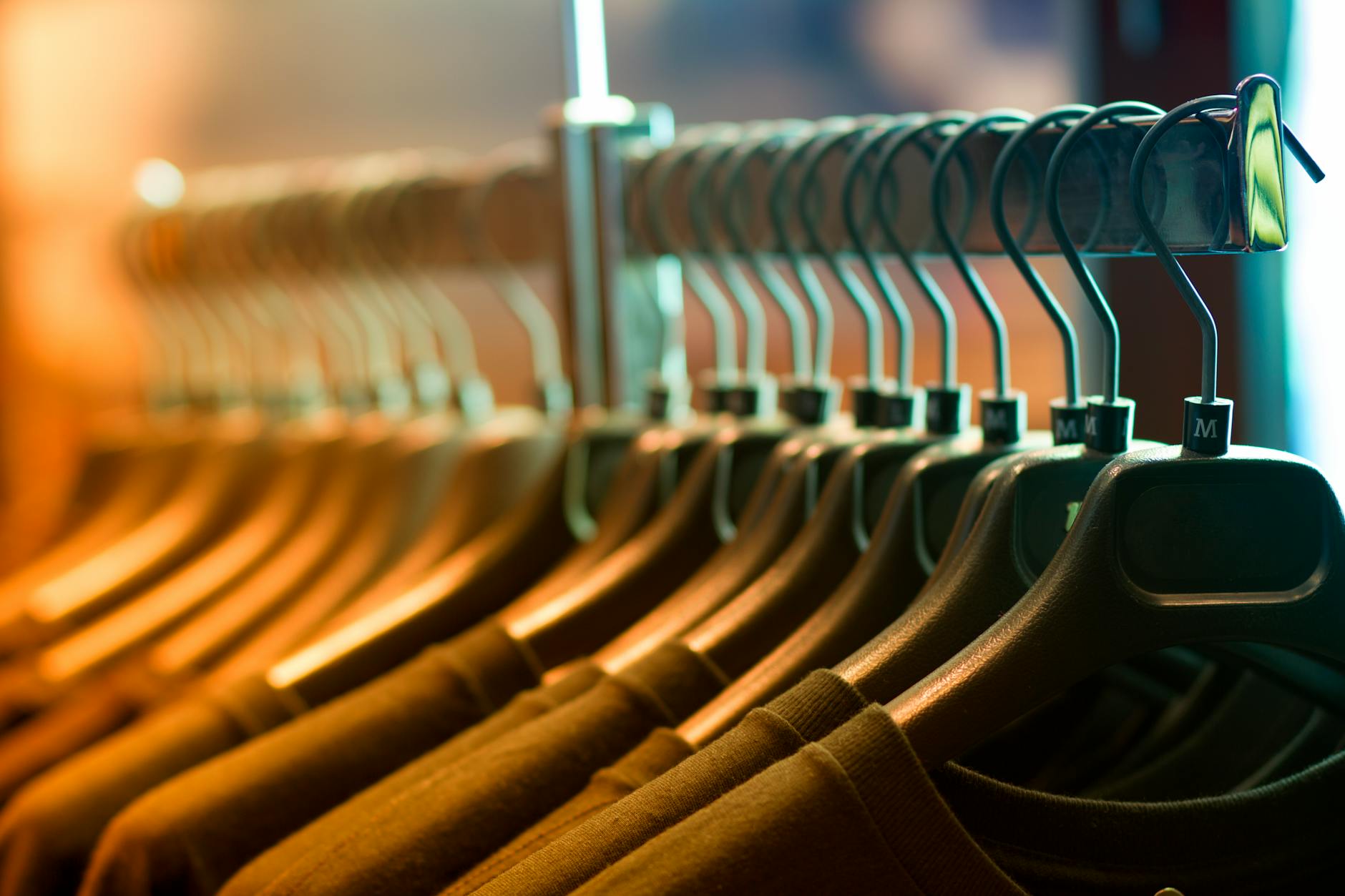 pile of shirts hanged in shirt rack