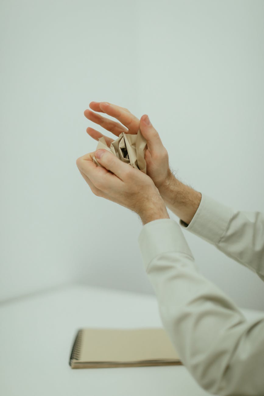 person holding a crumpled paper