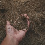 close up photo of person holding sand