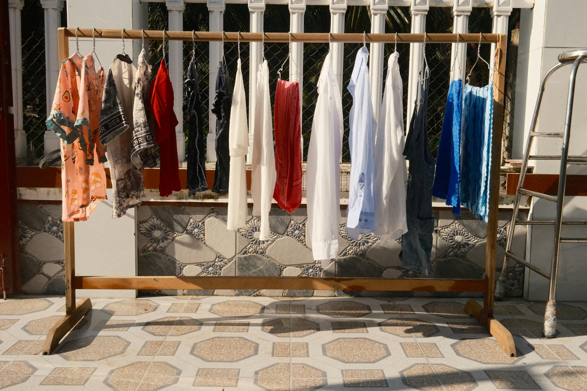 a rack of clothes with clothes hanging on it