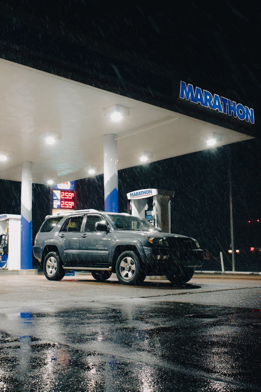 nighttime gas station scene with suv in snow