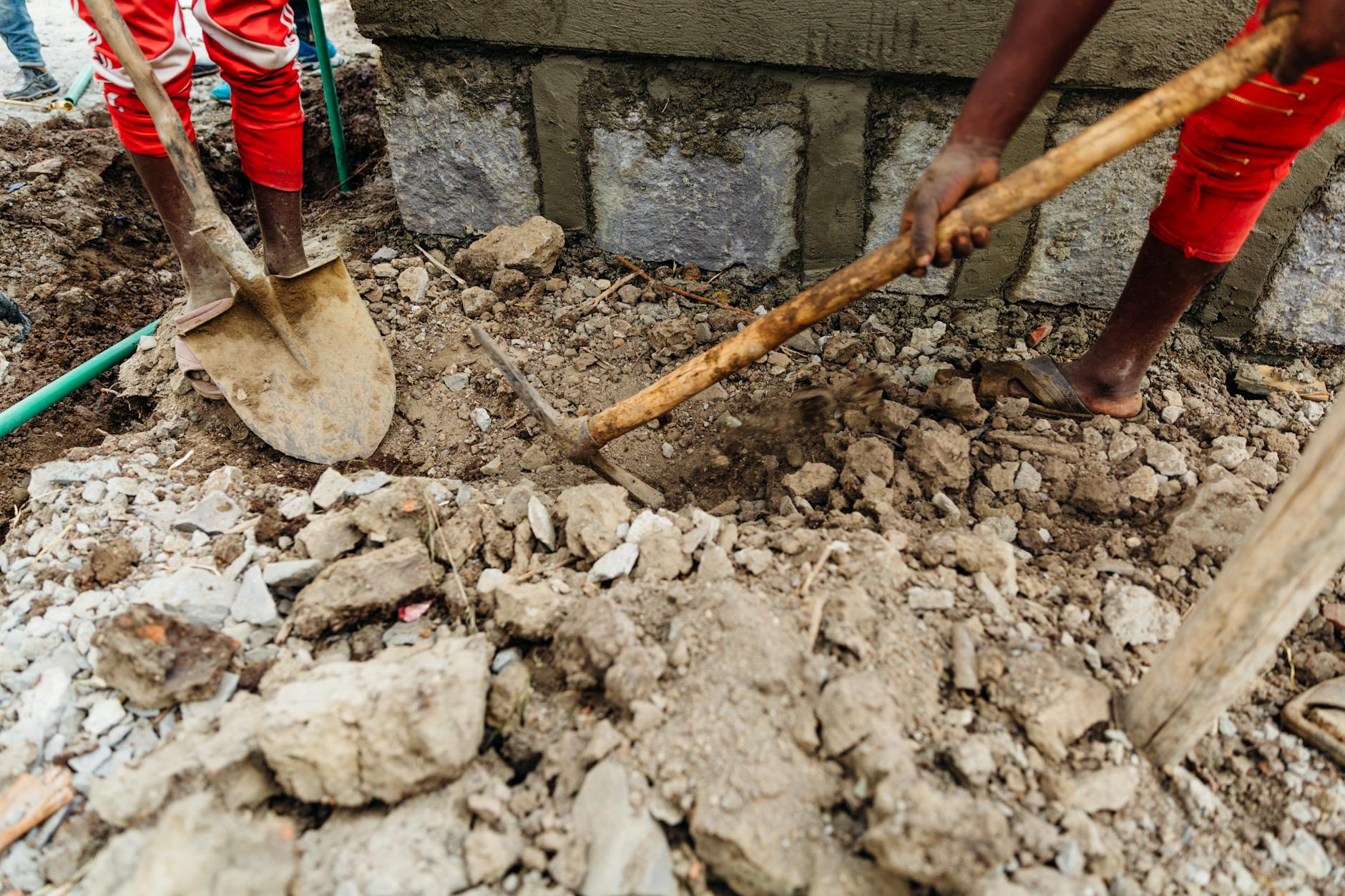 people digging using shovel and pickaxe