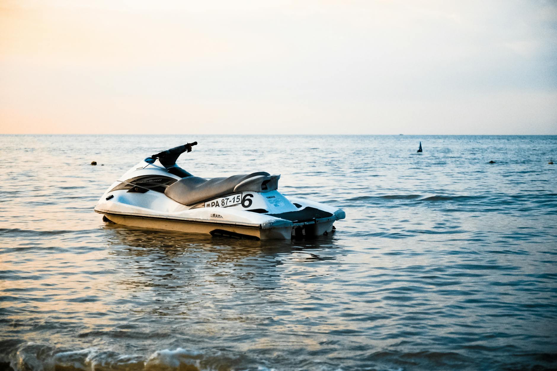 white and black personal watercraft on body of water