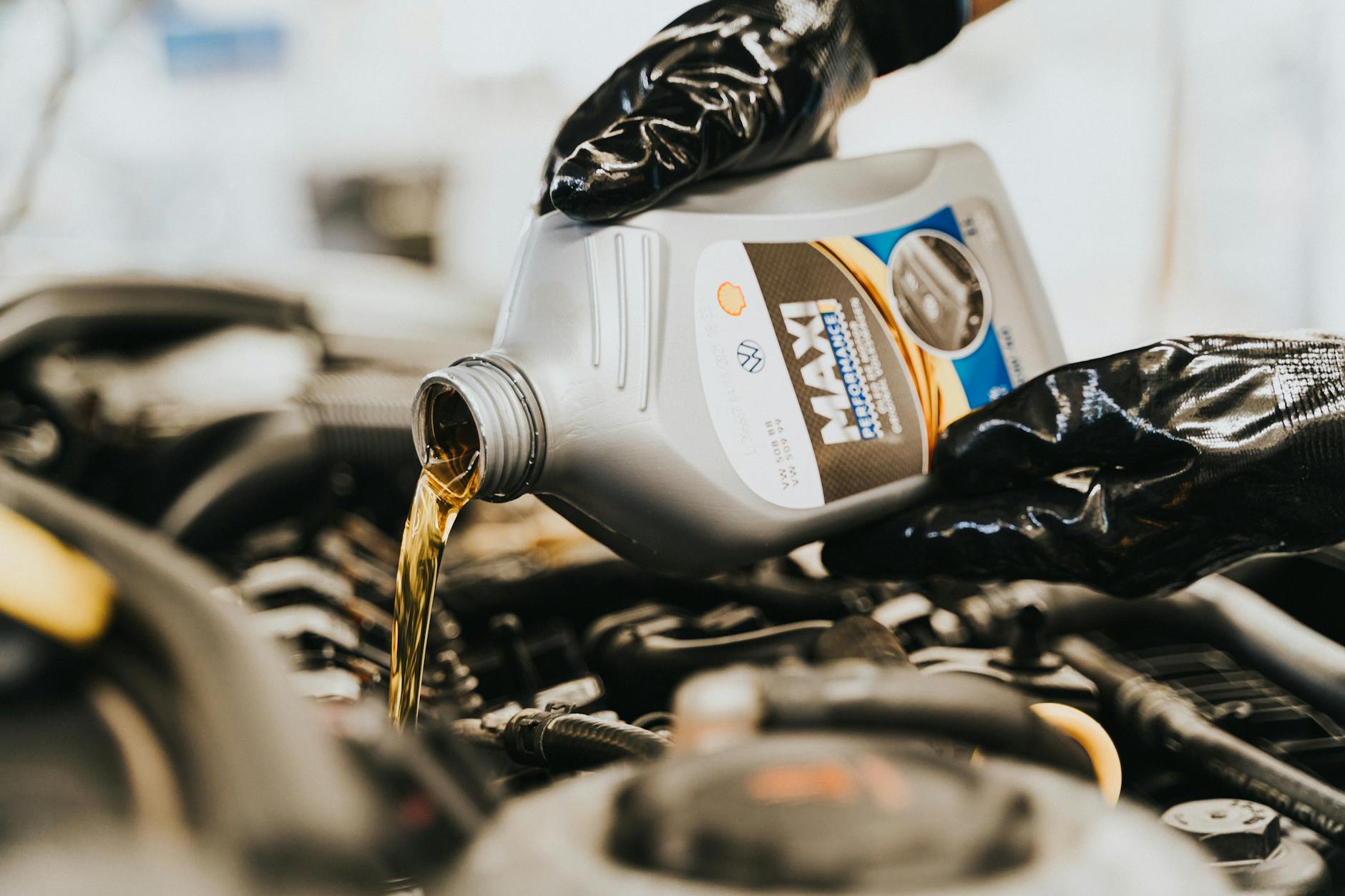 close up of pouring oil to engine