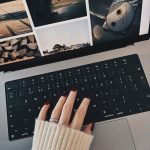 cozy workspace with hand on laptop keyboard