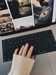 cozy workspace with hand on laptop keyboard