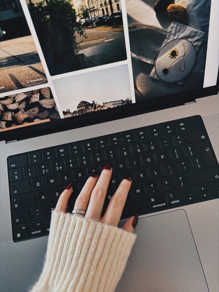 cozy workspace with hand on laptop keyboard