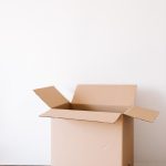 carton box and tape with scissors on shabby table